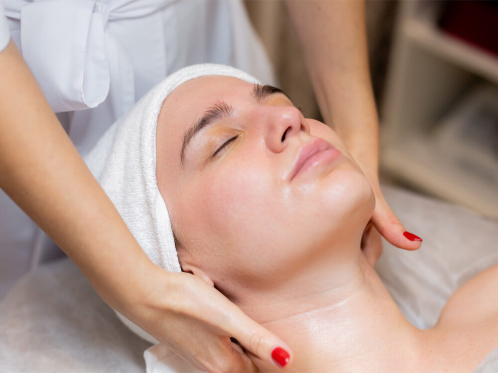 A young beautiful girl lies on the beautician's table and receives procedures